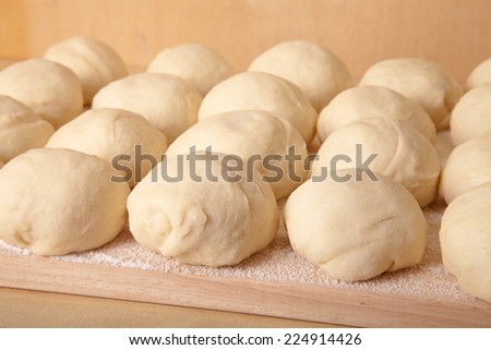 Small balls of dough with flour for pizza or cakes and scones. Shallow depth of field