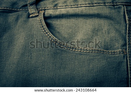 The pocket of jeans. Cloth background. Toned.