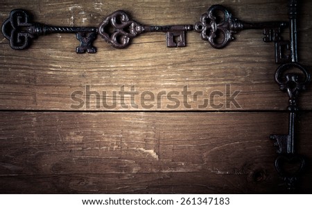 Vintage keys on old wooden boards. Frame or background. Space for text. Toned.