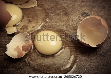 Broken eggs on the wooden floor.