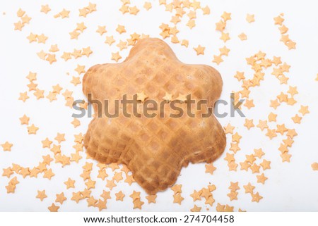Wafer and pastry decoration stars on a light background. Selective focus.