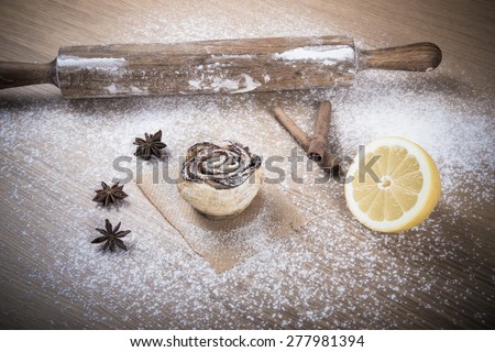 Homemade pastries on a light wooden table with flour. Toned.