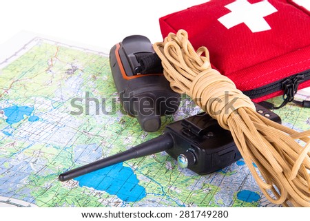 Map, gps navigator, portable radio, rope and first aid kit on a light background. Set lifeguard. Toned.