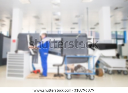 Abstract blur image, production space with operator of production equipment.