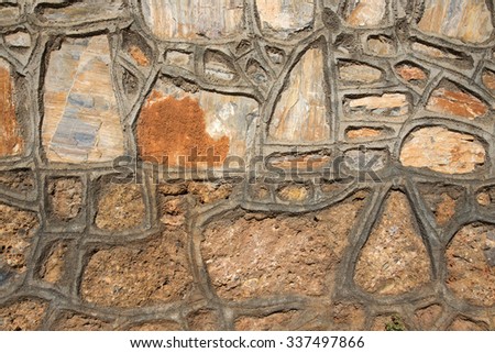 Fragment of stone texture wall or fence for natural material background. Closeup detail.