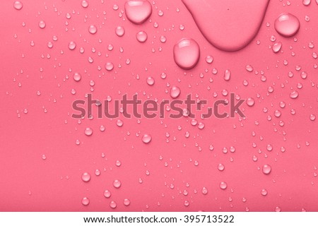 Drops of water on a color background. Pink. Toned.