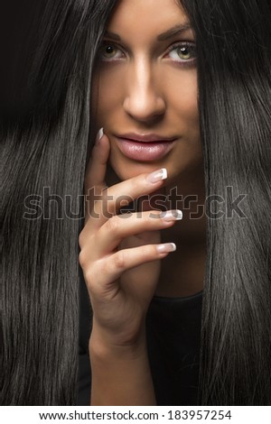 portrait of young beautiful woman with dark shiny hair
