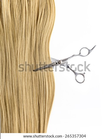 Scissors cut a lock of blond hair