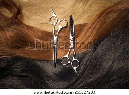 Thinning scissors against the dark red and blond hair
