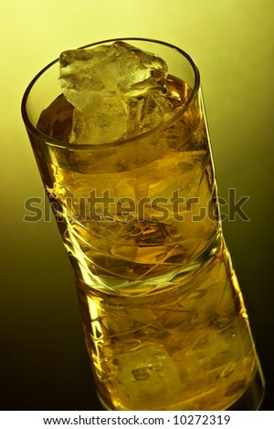 Still life with glass with whiskey on the black background