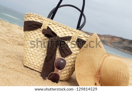 Sea time - seacoast, straw beach bag and sunglasses