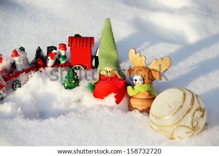 Christmas decoration small funny boy with elk in the snowdrift