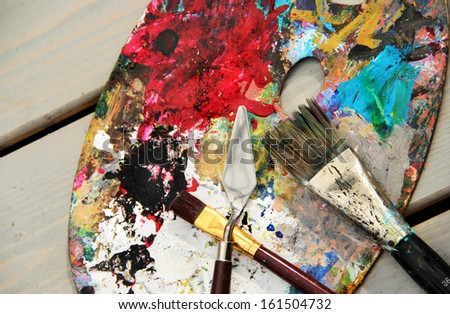 Art palette and brushes with a lot of vivid colors