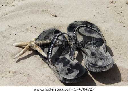 Summer shoes on the beach with white sand and starfish