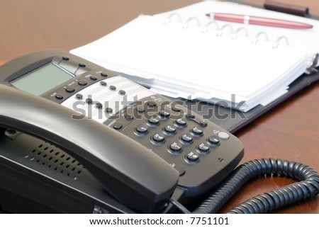 Business telephone and day planner.