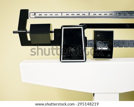 Physician Beam Scale - Medical professional sliding balance weight scale at a physician\'s office