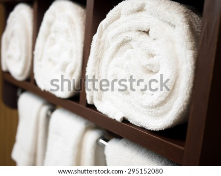 Rolled towels in a hotel bathroom towel rack