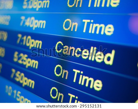 Airport flight cancelled. Airport arrival and departure monitor sign showing on-time and cancelled flight status
