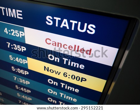 Flight cancelled. Airport arrival and departure board sign showing on-time and cancelled flight status