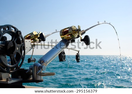 Fishing Poles on Boat. Picture of two fishing poles in rod holders on the back of a boat.