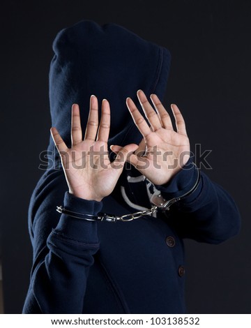 Women in handcuffs avoiding being photographed