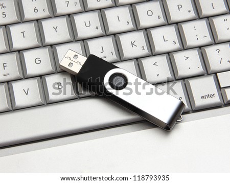 USB thumb drive on a laptop keyboard
