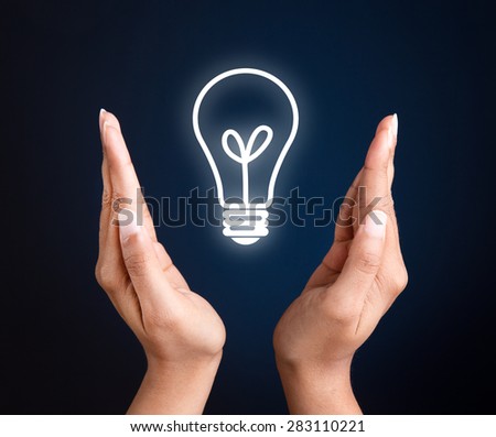 Hand holding a white glowing light bulb. concept image for idea, creativity & strategy.