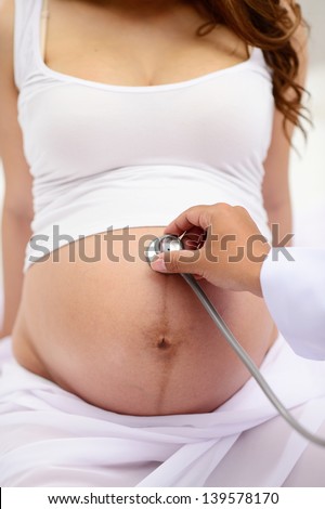 doctor listen big stomach pregnant woman