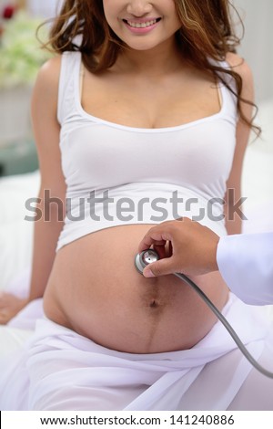 doctor listen big stomach pregnant woman