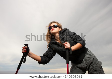 Girl with tourist stick on nature