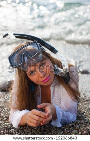 Woman snorkeler with goggles, and snorkel smiling in summer bikini