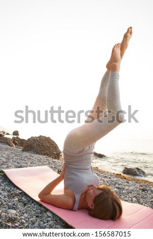Yoga women practising her strength and balance