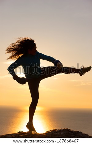 Silhouette of the girl boxer on background sunrise