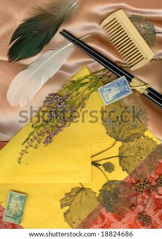 Textile background with old letters, dry flowers, postage stamps and feather.