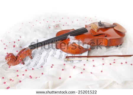 Violin and notes on white silk background with boa and furs