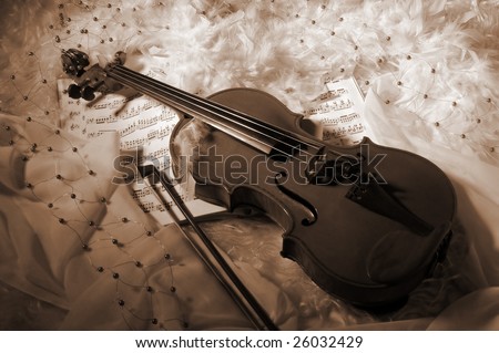 Violin and notes on silk background with boa and furs
