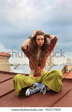 Young girl sitting on a iron roof