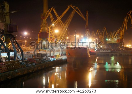 Container ship in a sea night industrial freight port