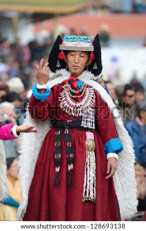 LEH, LADAKH, INDIA - SEPTEMBER 08, 2012: Woman in traditional tibetan costumes performing folk dance. Last day of Annual Festival of Ladakh Heritage in Leh, India. September 08, 2012.