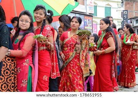 Kathmandu, Nepal - September 18, 2012: Hindu women in traditional red sari celebrating the Haritalika Teej festival on the streets of Kathmandu, Nepal