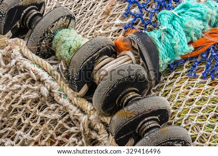 White fishing net with black wheels.
