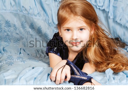 Portrait of cute girl lying in the bed