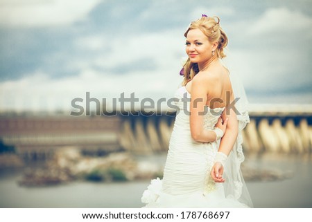 Romantic lady in bridal dress and flowers in hair have final preparation for wedding