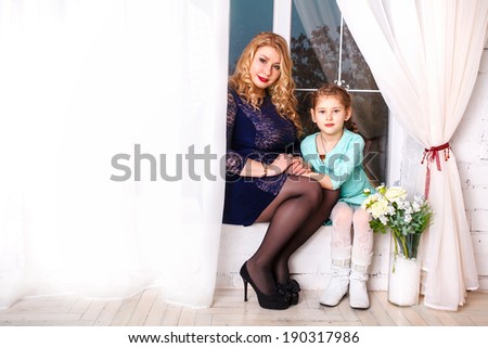 Mothers day holiday concept. mother and little daughter with flowers