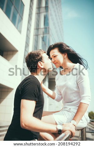 Young couple kissing outdoor in summer sun light. Kiss love date color evening teen.