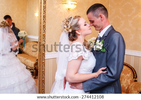 Wedding couple newlywed bride and groom in love at wedding day . Happy loving couple at bridal day embracing. newlywed with bouquet flowers. Relationship. Smiling wife and husband kiss