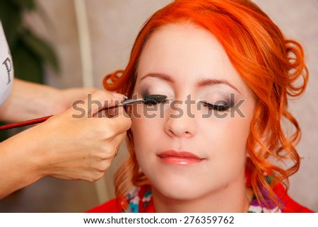 bridal make-up. beautiful bride in white wedding dress with hairstyle and bright makeup. Happy sexy girl waiting for groom.