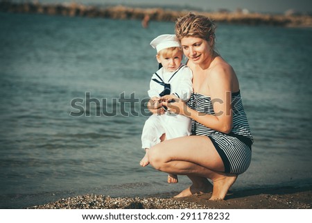 Happy family. Young happy beautiful mother and her son having fun on the beach. Positive human emotions, feelings, emotions.