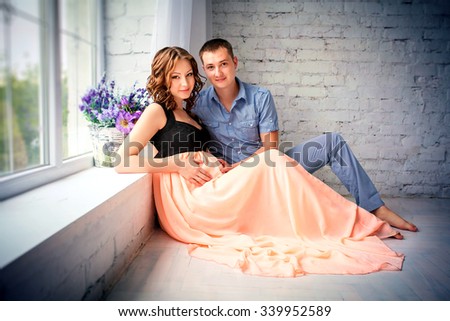 happy family in anticipation of the birth of the baby. Pregnant woman and her husband  at home