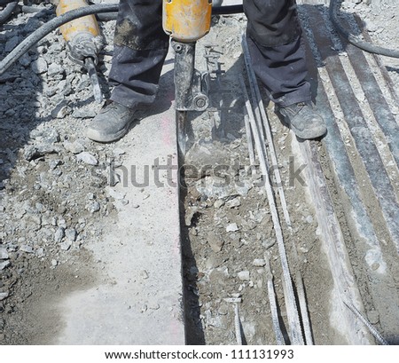 Man jack-hammering up the concrete